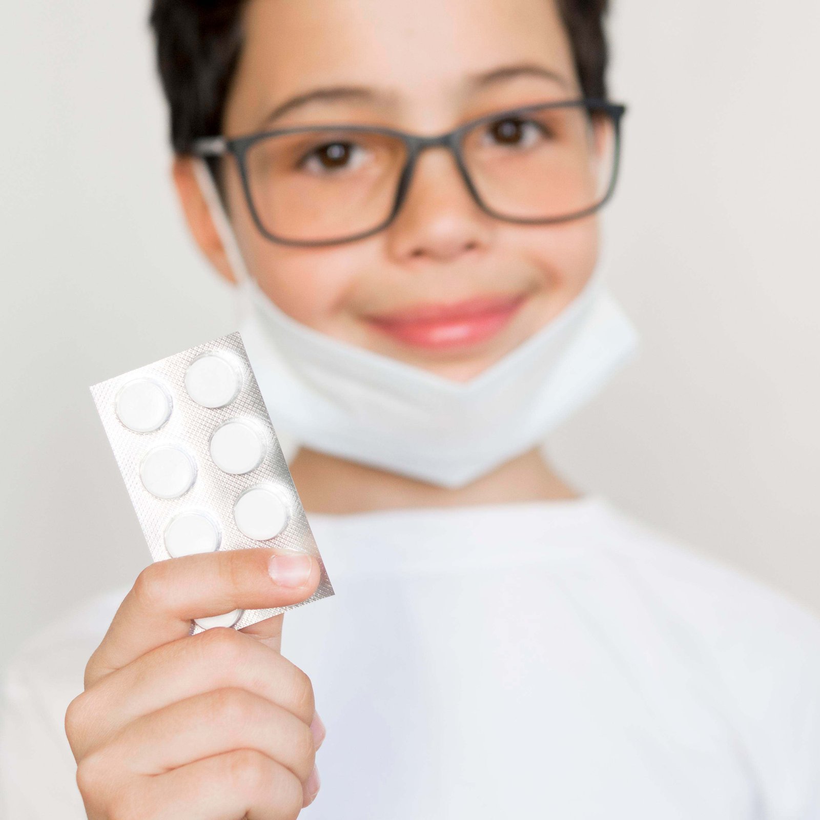 boy with mask holding pills tablet 11zon (1)