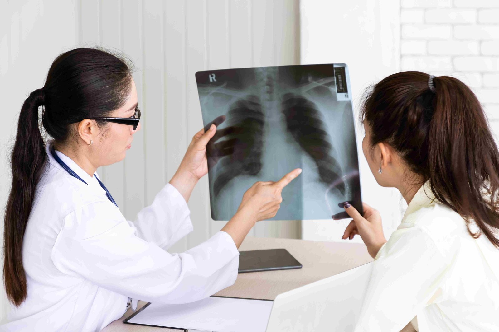 medical doctor give consultation patient with xray film 11zon